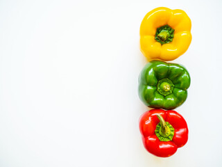 Red, green and yellow bell peppers isolated in white background