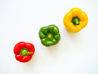 Red, green and yellow bell peppers isolated in white background