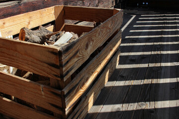 logs on the wooden box, shadows of fence