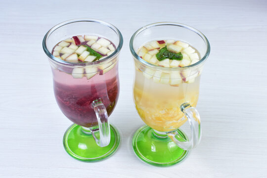 Colorful Italian Sodas With Chopped Fruits On White Wooden Background