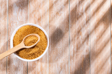 Organic brown sugar in the wooden bowl - Saccharum officinarum