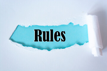 The word rules appearing behind torn paper