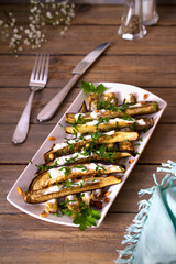Eggplants or aubergines with yoghurt sauce, nuts and parsley. Vertical photo