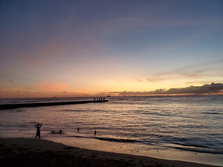 swimming near the jetty during a hawaiian sunset