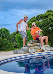 Two men being silly by the pool