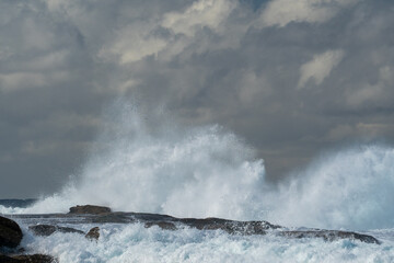 wild surf waves hitting the coastal cliffs of maroubra beach in Sydney Australia