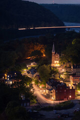 Blue hour at Harper's Ferry as cars drive through the historic Civil War town and across the...