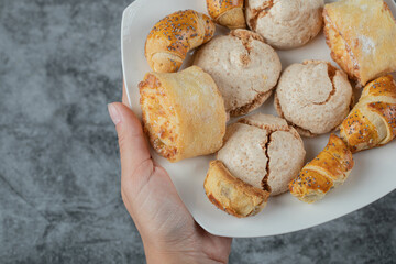 Butter cookies with sugar powder in a white ceramic plate