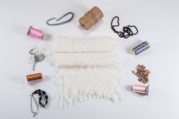 top view flat lay on handmade white woolen scarf with knitted pattern