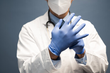 male doctor wears clean protective gloves before examination