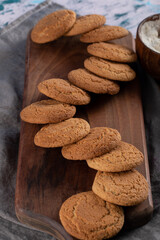 Oatmeal cookies on a wooden board in a row