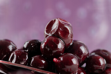 Red blackcurrant confiture in the saucer and in a metallic spoon