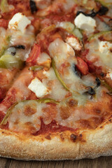 Pizza with mixed ingredients and melted cheese on the top