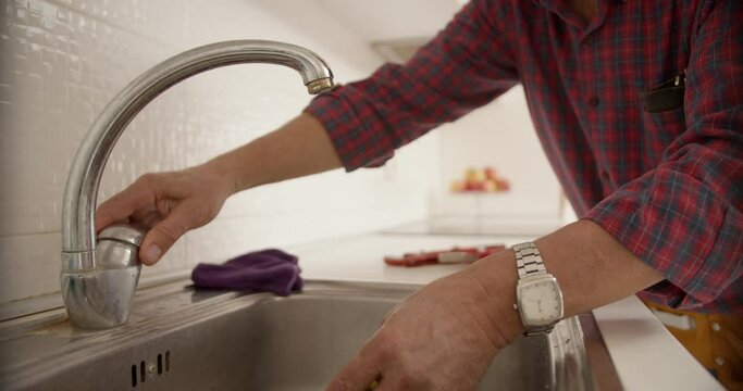 Plumber Inspecting The Faucet