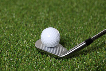 Golf balls and clubs on the grass