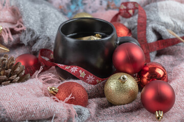 Red and golden christmas figures in the cup and around it
