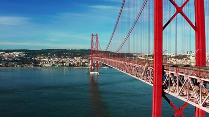 Drone footage of the 25 De April Bridge. Red bridge in Lisbon, Portugal. Tagus