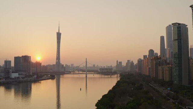 View of Pearl river and downtown CBD district and Park along river side at beautiful golden sunset. Guangzhou, Guangdong, China.
