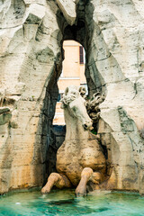 Fototapeta na wymiar Italy, Rome. Piazza Navona, Fountain of the Four Rivers (Fontana dei Quattro Fiumi), designed 1861 by Bernini, horse between two gods (Plata and Danube).