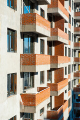 windows and balconies made of bricks of a new house under construction. monolithic construction