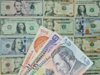 approach to honduran banknotes and background with american dollar bills