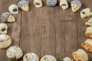 Variety of cookies standing on a wooden background