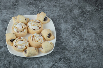Butter cookies with sugar powder in a white ceramic plate