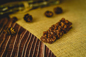 Chocolate crispy wafer bar on brown fabric. Close up of chocolate wafer with props. selective focus food.