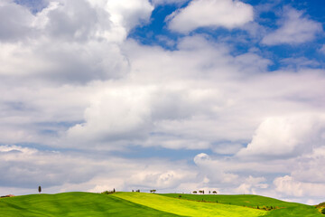 Europe, Italy, Tuscany, Val d' Orcia. Cloudy sky and agricultural landscape.