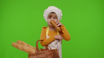 Child girl dressed in apron like chef cook showing basket with baguette and bread, smiling, sniffing, eating bun with cream on chroma key background. Nutrition, cooking school, children education