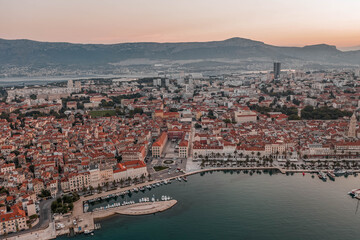 Aerial drone shot of Republic Palace by Diocletian Palace in Split old town before sunrise in morning