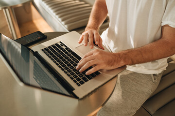 Fototapeta na wymiar Man sitting in cafe and working in laptop