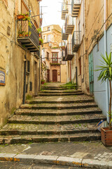 Fototapeta na wymiar Italy, Sicily, Palermo Province, Castelbuono. Stairs on a narrow street in Castelbuono.