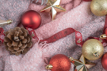 Christmas tree cones, figures and ribbon on the pink towel