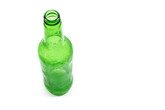 cloudy green empty beer bottle on white background close-up, top view