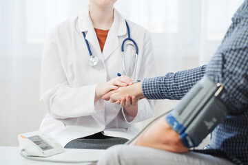 doctor and patient measuring blood pressure, healthcare, hospital and medicine concept