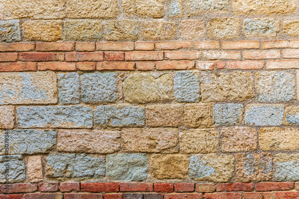 Wall mural italy, sicily, palermo province, a stone wall with brick inlay in the town of gangi.