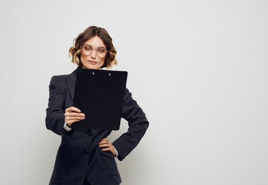 Business woman with folder of documents classic suit glasses finance