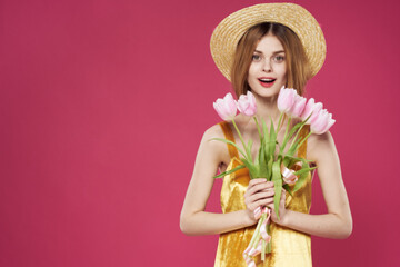 Woman in a hat with a bouquet of flowers as a gift for Valentine's Day holiday