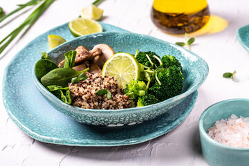 Green vegetable vegan salad with spinach, mushrooms and broccoli and quinoa. Healthy vegetarian food concept. top view