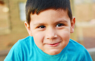 Obraz premium Sly little latin boy smiling.