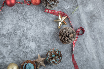 Oak cones with red and golden ornaments and a Christmas style ribbon