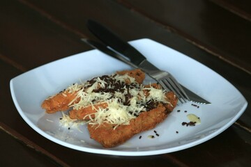 Indonesian fried banana food with delicious chocolate and cheese sprinkles.
