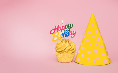 Composition with birthday cupcake on pink background