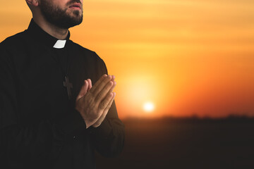 Young priest praying to God in morning
