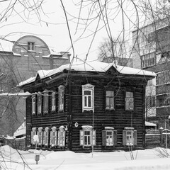 Old wooden houses under the snow. Russia. Siberia. Winter. The city of Tomsk 2021