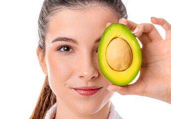 Beautiful young woman with avocado on white background, closeup