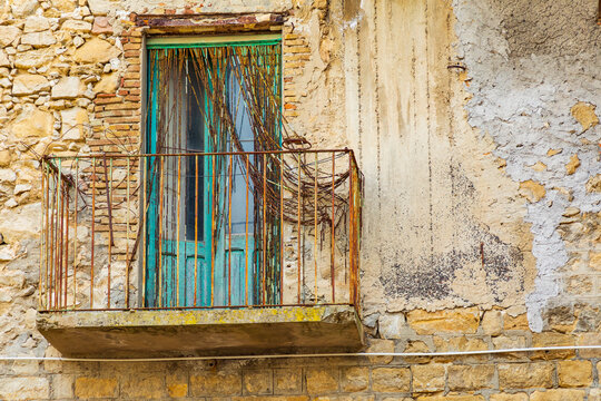 Italy, Sicily, Enna Province, Centuripe. A rusted balcony on a rustic building in the hill town of Centuripe.