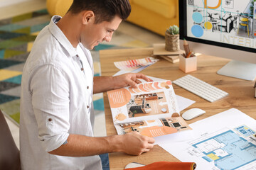 Male interior designer working in his office