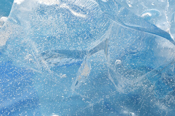 Beautiful natural ice block closed up splitted with frozen air bubbles